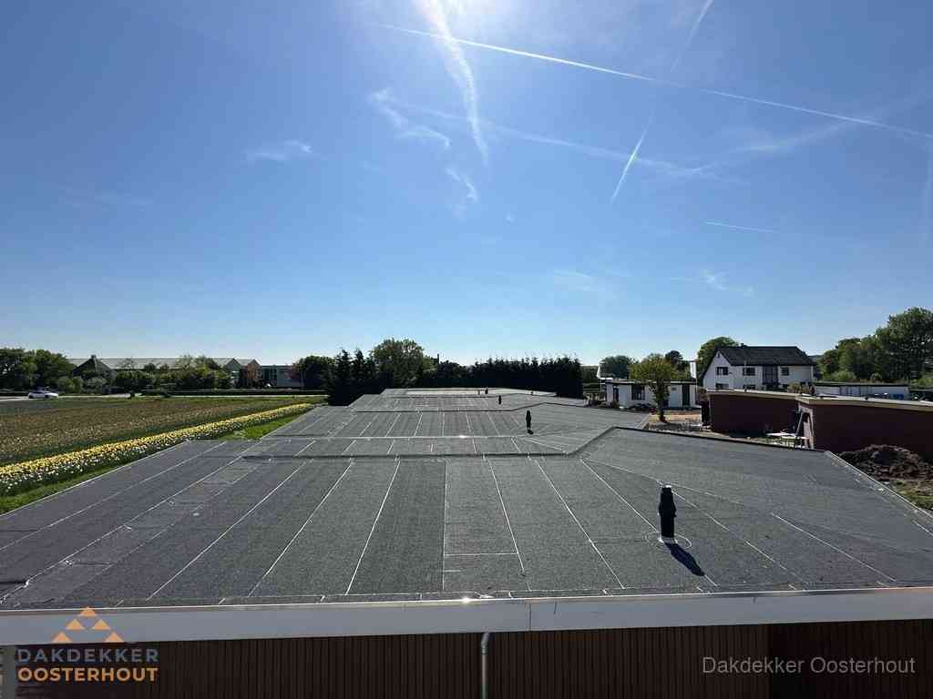 Groot plat dak met bitumen dakbedekking op bedrijfspand in Oosterhout